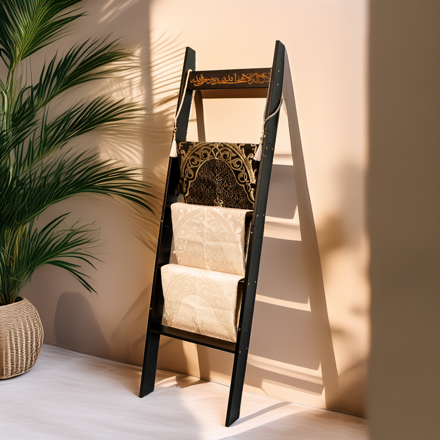 Black Shahadah ladder leaning against a wall to display prayer rugs and hijabs.